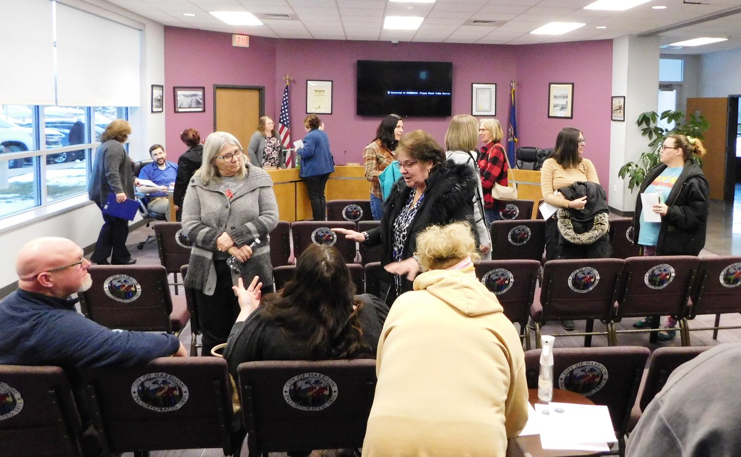 After the City of Harrison’s Feb. 20 public forum seeking commentary on the Harrison City Market, some of the many attendees linger to continue their discussion of ideas for possible self-sustaining uses for the that facility.